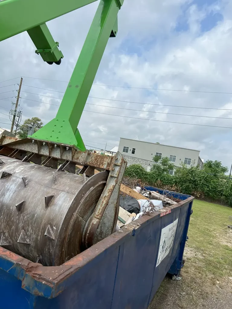 A photo of a dumpster compactor at work from QuickCompact.