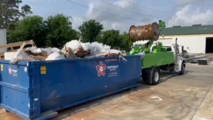 A photo of a Quick Compact truck providing Dumpster Compaction services in Houston Texas, Spring Texas, the woodlands, katy texas